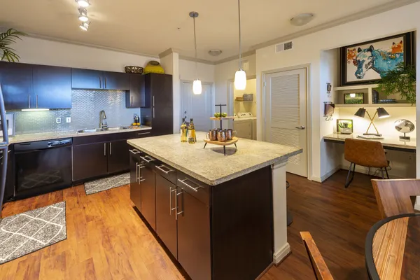 a kitchen with a sink and wooden cabinets