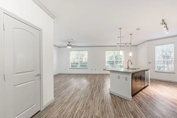 a kitchen with stainless steel appliances granite countertop a stove and wooden floor