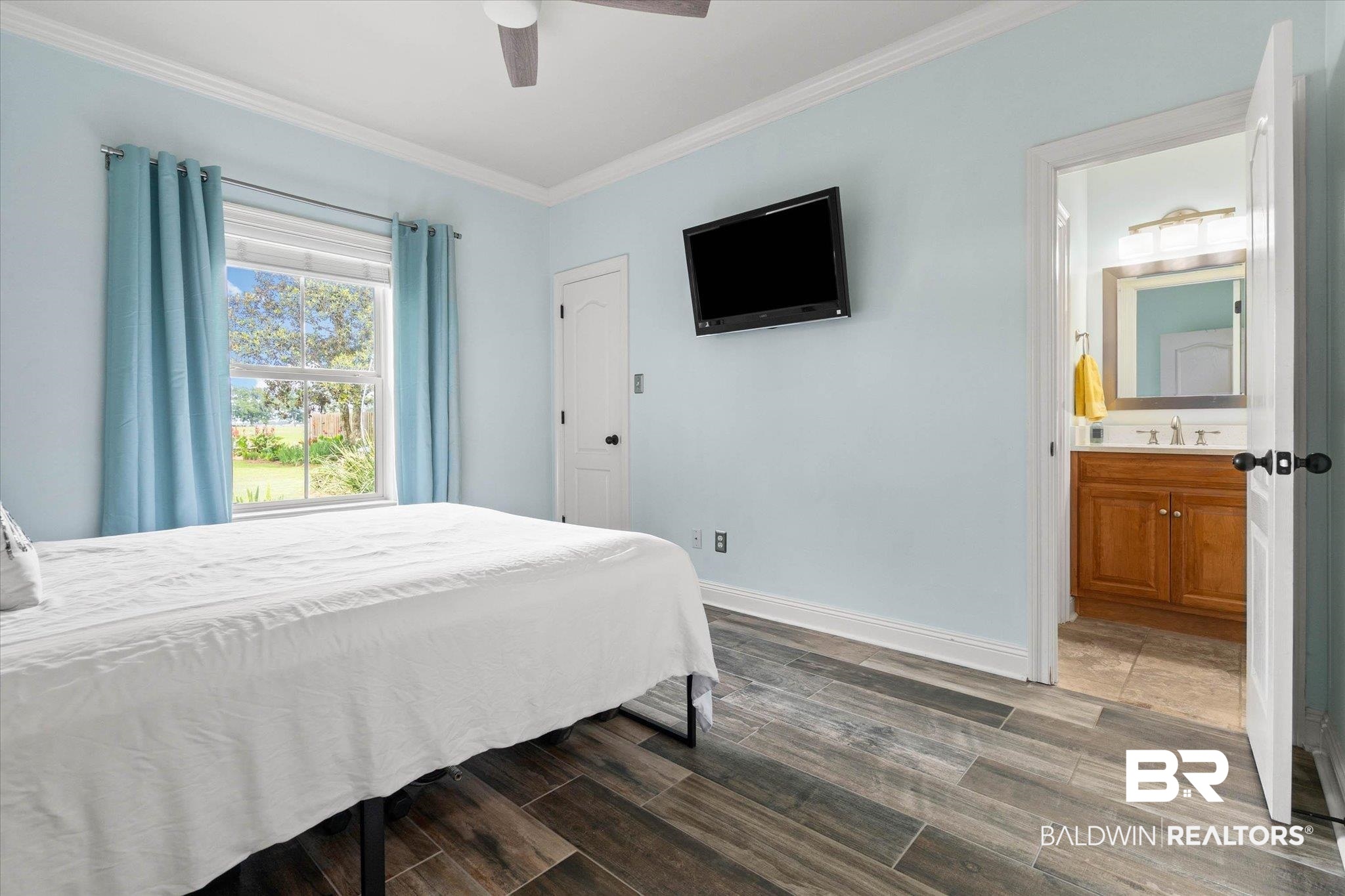 24908 Bosbyshell Avenue Daphne, AL 36526 - Photo 16 of 49 Room featuring wood-finish flooring, a ceiling fan, and a light-toned wall color