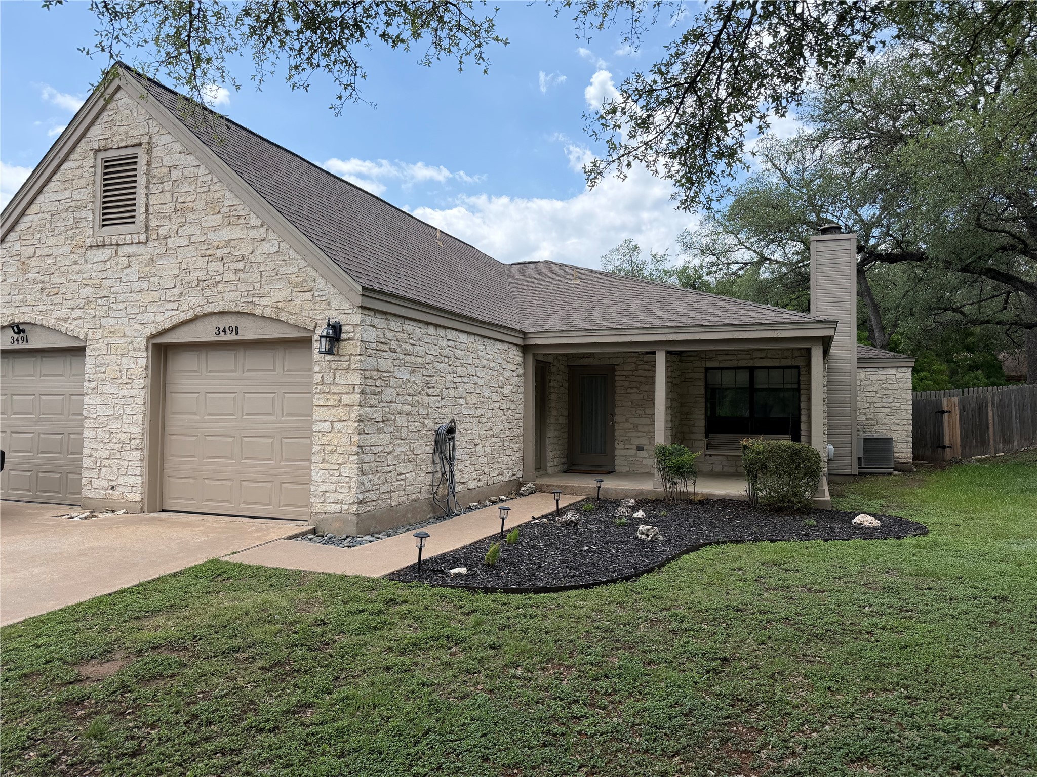 349 Fantail Loop, Unit B Austin, TX 78734 - Photo 6 of 9 a view of a house with backyard and sitting area