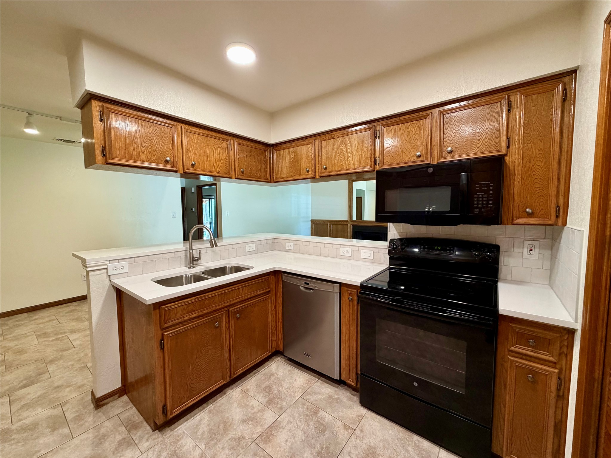 349 Fantail Loop, Unit B Austin, TX 78734 - Photo 9 of 9 a kitchen with a sink stove and microwave