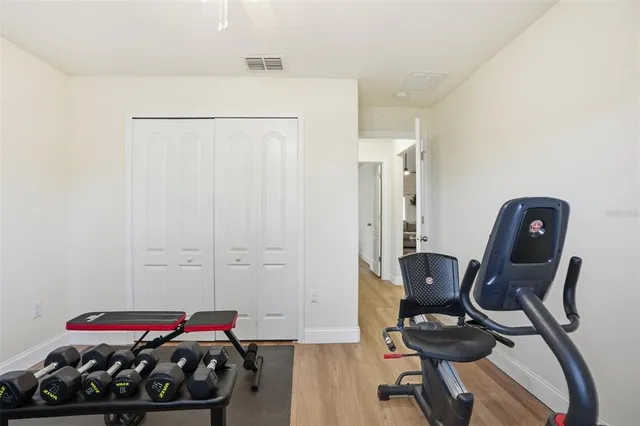 a view of a workspace with furniture and a closet