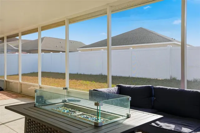 a living room with furniture and floor to ceiling window