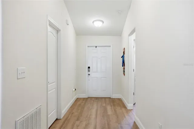 a view of a hallway with wooden floor