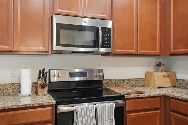 a kitchen with granite countertop a stove and a sink