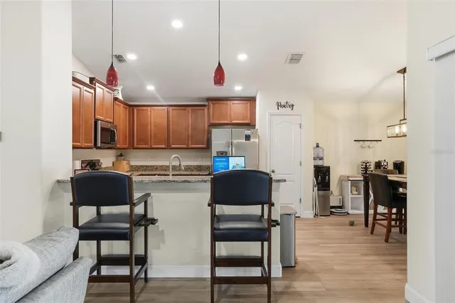 a kitchen with cabinets and chairs