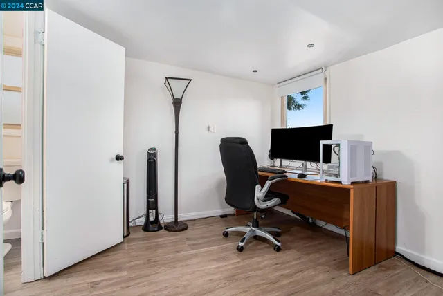 a view of a workspace with furniture and a workspace