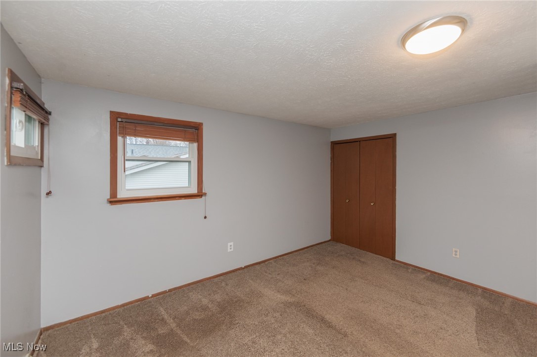 28013 Knickerbocker Road Bay Village, OH 44140 - Photo 20 of 38 Second floor bedroom with a textured ceiling, a closet, and carpet