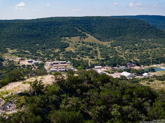 a view of a houses with green field