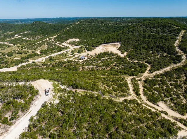 a view of a lake in middle of green field