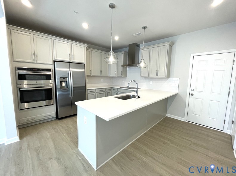 13327 Coalfield Station Lane Midlothian, VA 23114 - Photo 3 of 10 a kitchen with kitchen island a sink stainless steel appliances and counter space