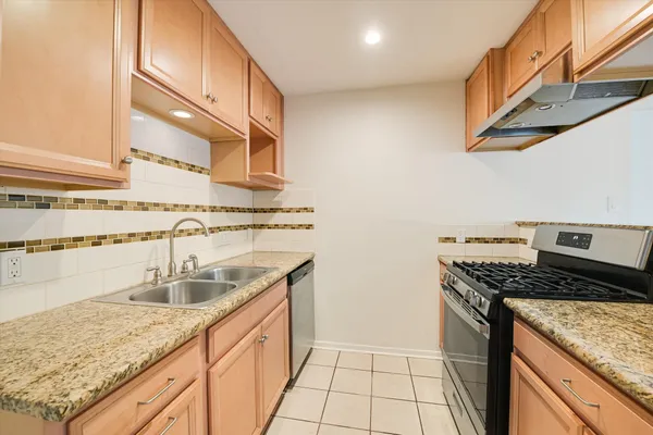 a kitchen with stainless steel appliances granite countertop a sink and cabinets