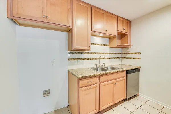 a kitchen with stainless steel appliances granite countertop a sink and cabinets