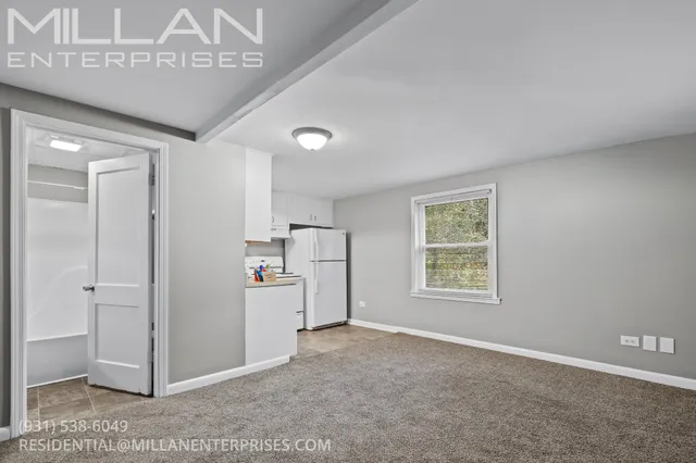 a view of a livingroom with an empty space and a window