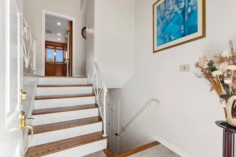 a view of staircase with white walls and a window