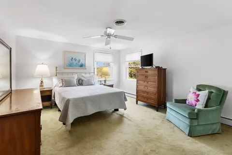 a bedroom with a bed furniture and a flat screen tv