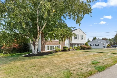 a house that has a tree in front of it