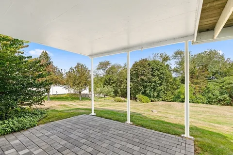 a view of a room with wooden floor and fence