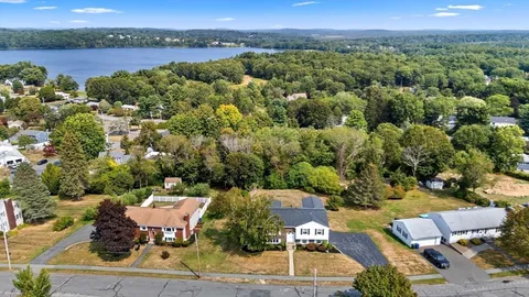 an aerial view of a house with a yard
