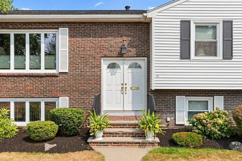 a front view of a house with a garden