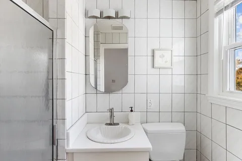 a bathroom with a sink toilet and shower