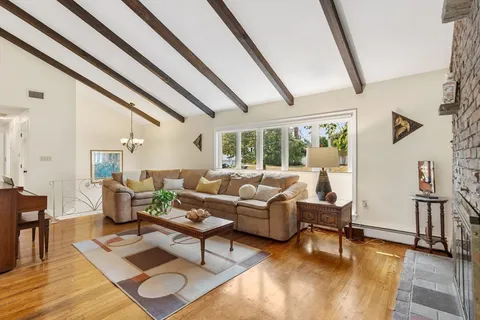 a living room with furniture and a floor to ceiling window