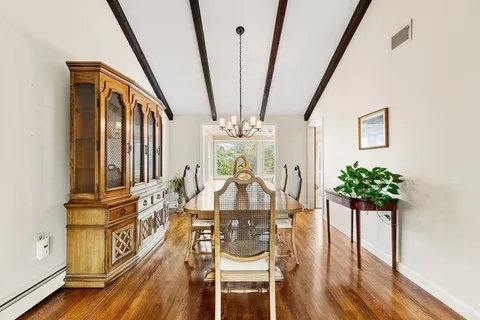 a view of a dining room with furniture wooden floor and chandelier