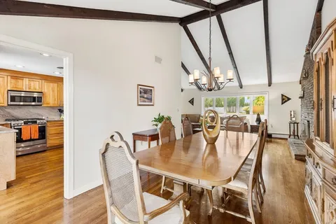 a dining room with furniture window and wooden floor