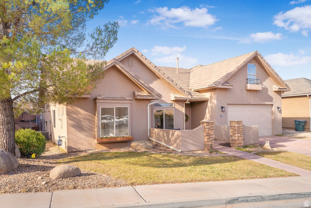 1570 South Rio Virgin Drive Washington, UT 84780 - Photo 1 of 71 Traditional-style home featuring concrete driveway, stucco siding, a garage, a front yard, and a tiled roof