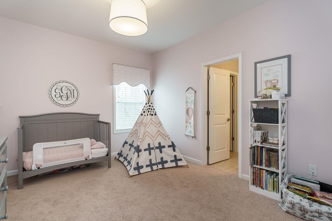5602 Wade Park Boulevard Raleigh, NC 27607 - Photo 24 of 34 Upstairs bedroom with generous sized closet with wooden shelving and shared bath. Bedroom