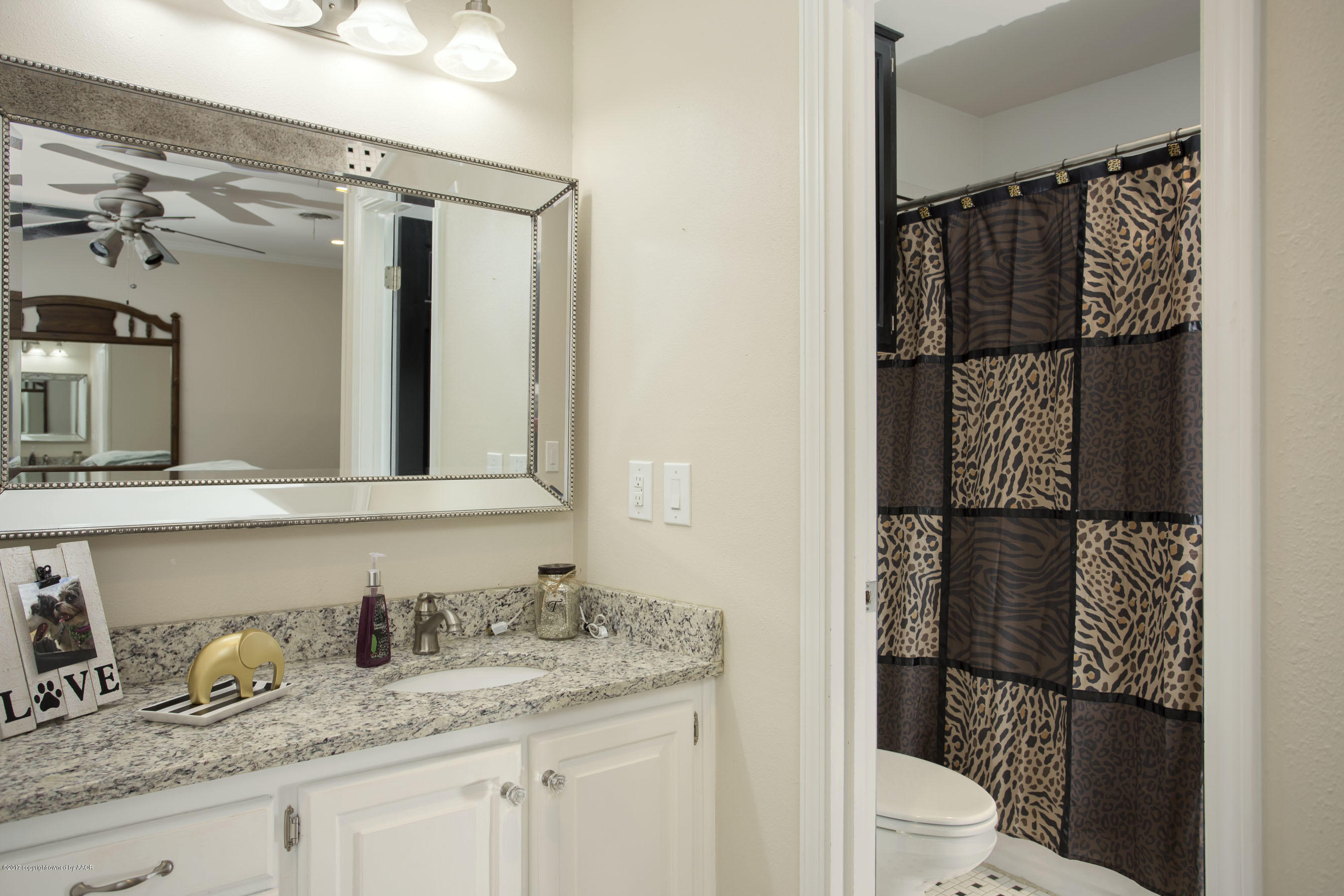 8324 Lamount Drive Amarillo, TX 79110 - Photo 17 of 26 a bathroom with a granite countertop sink toilet and shower