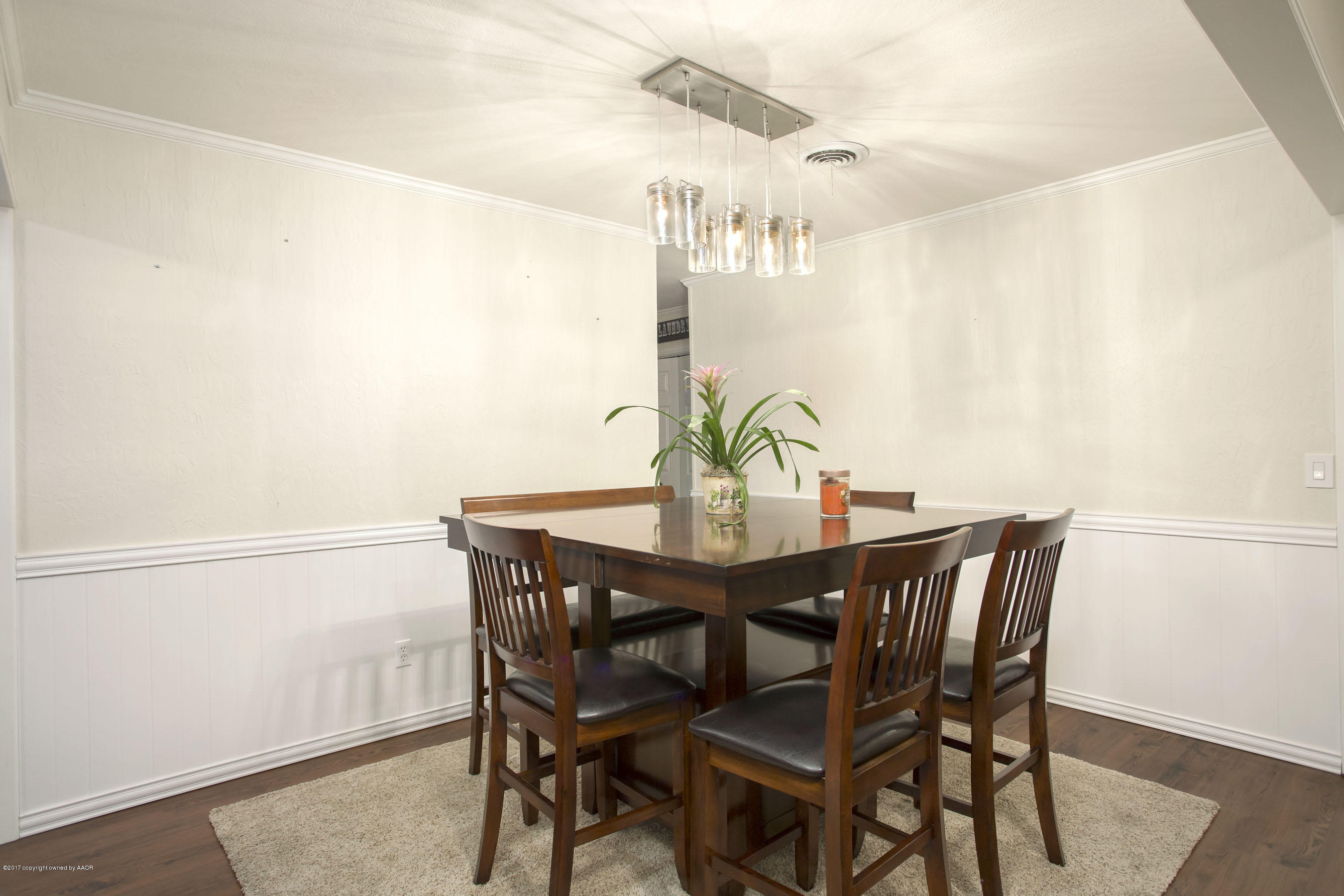 8324 Lamount Drive Amarillo, TX 79110 - Photo 8 of 26 a view of a dining room with furniture and wooden floor