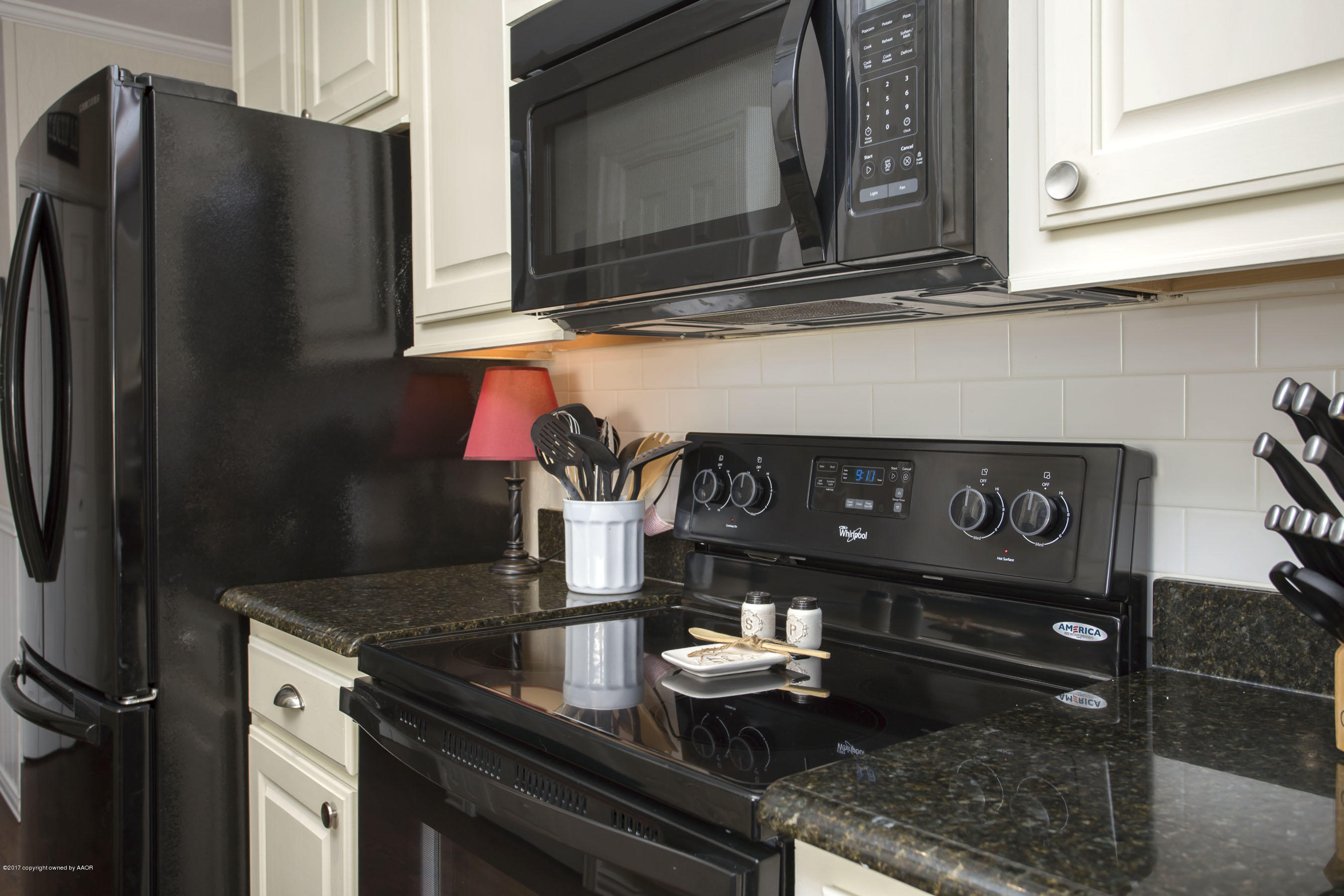 8324 Lamount Drive Amarillo, TX 79110 - Photo 9 of 26 a kitchen with a stove and a microwave