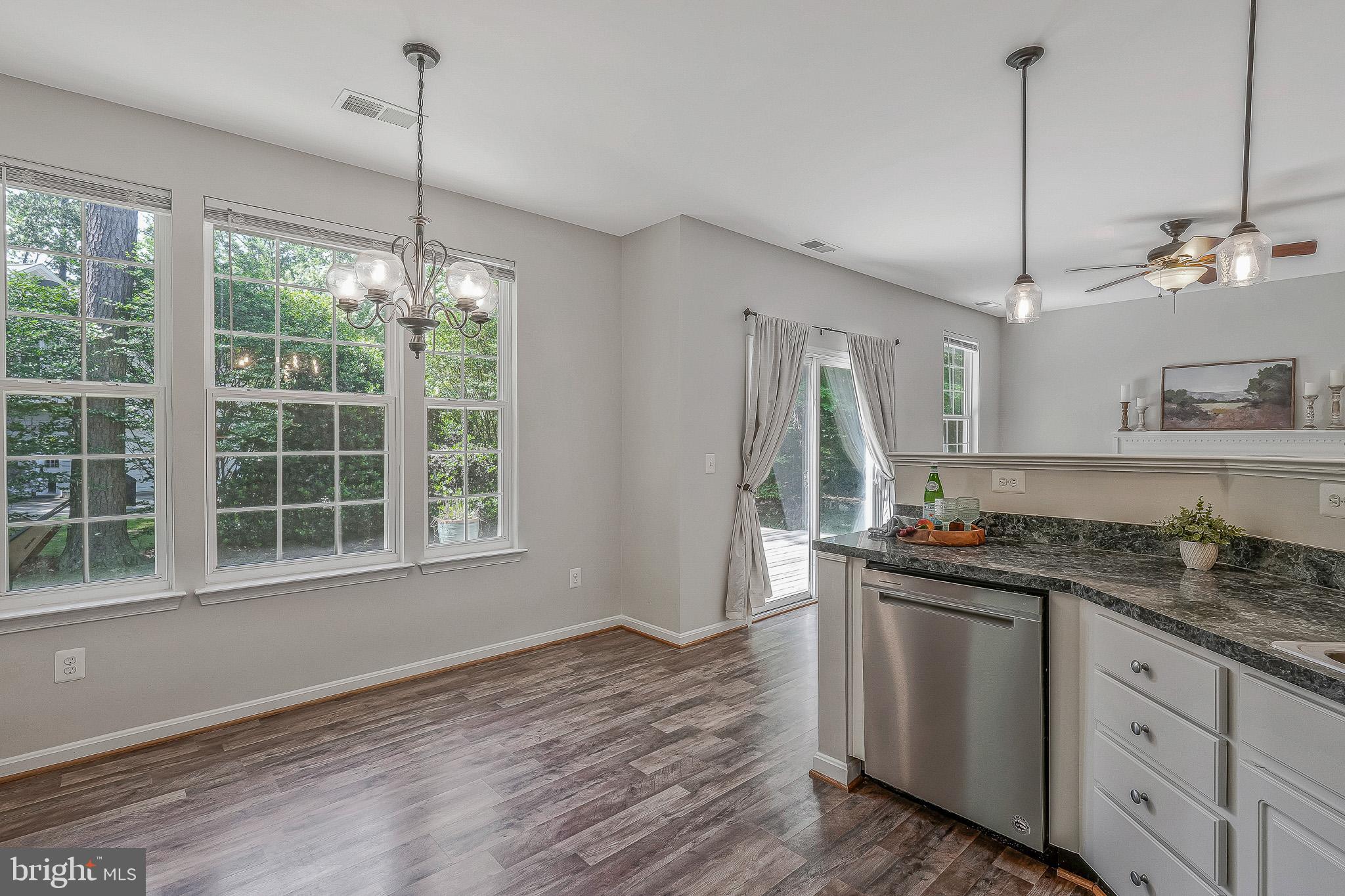 11587 Wollaston Circle Swan Point, MD 20645 - Photo 12 of 55 a kitchen with a sink stove and wooden floor