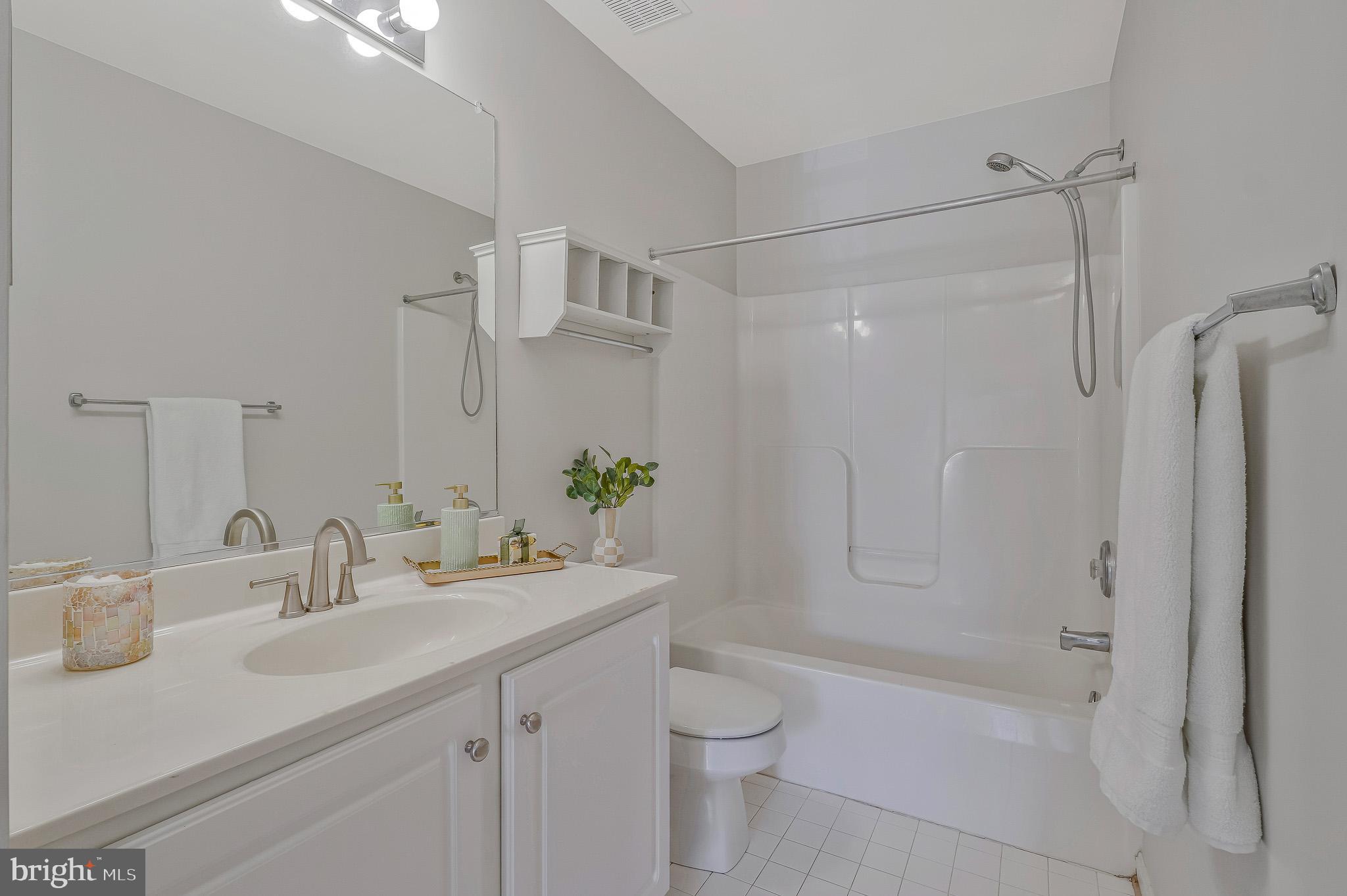 11587 Wollaston Circle Swan Point, MD 20645 - Photo 29 of 55 a bathroom with a sink toilet vanity and shower