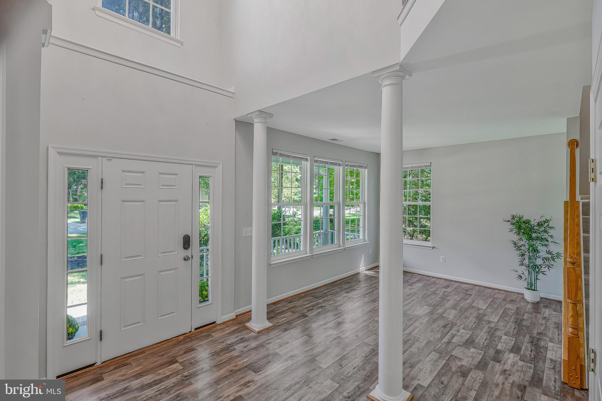 11587 Wollaston Circle Swan Point, MD 20645 - Photo 4 of 55 an empty room with windows and entrance