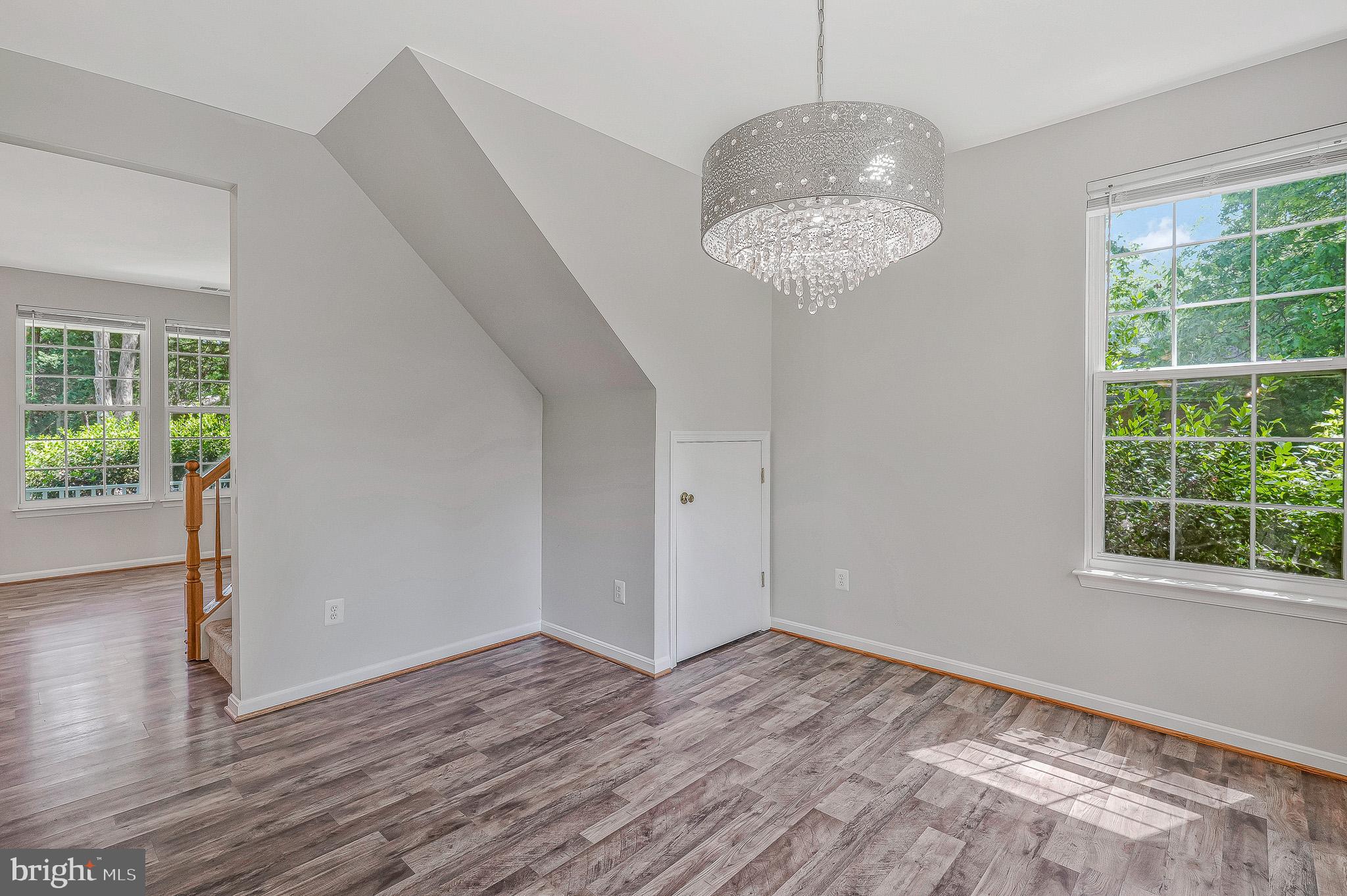 11587 Wollaston Circle Swan Point, MD 20645 - Photo 7 of 55 a view of an empty room with wooden floor and a window