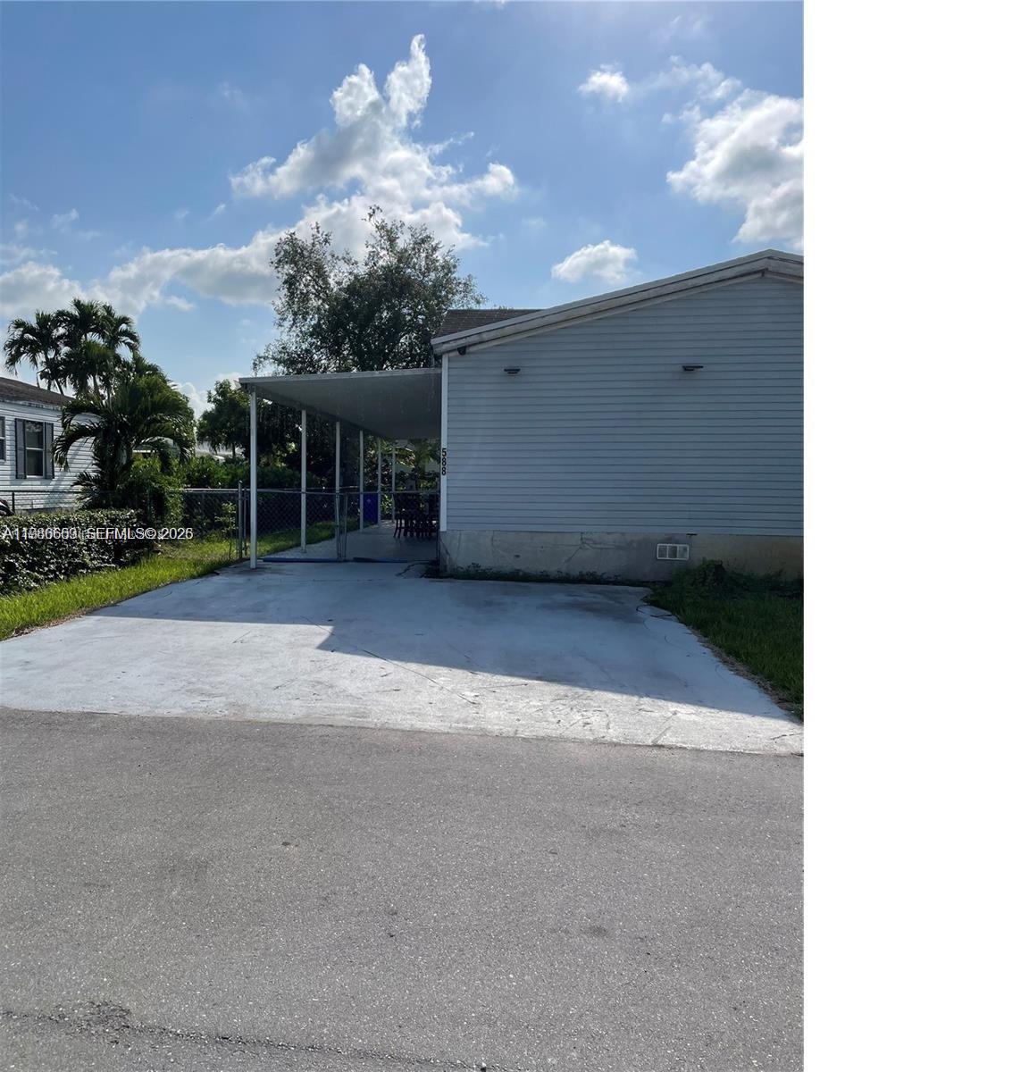 19800 Southwest 180th Avenue Miami, FL 33187 - Photo 1 of 9 a view of a house with a yard and garage