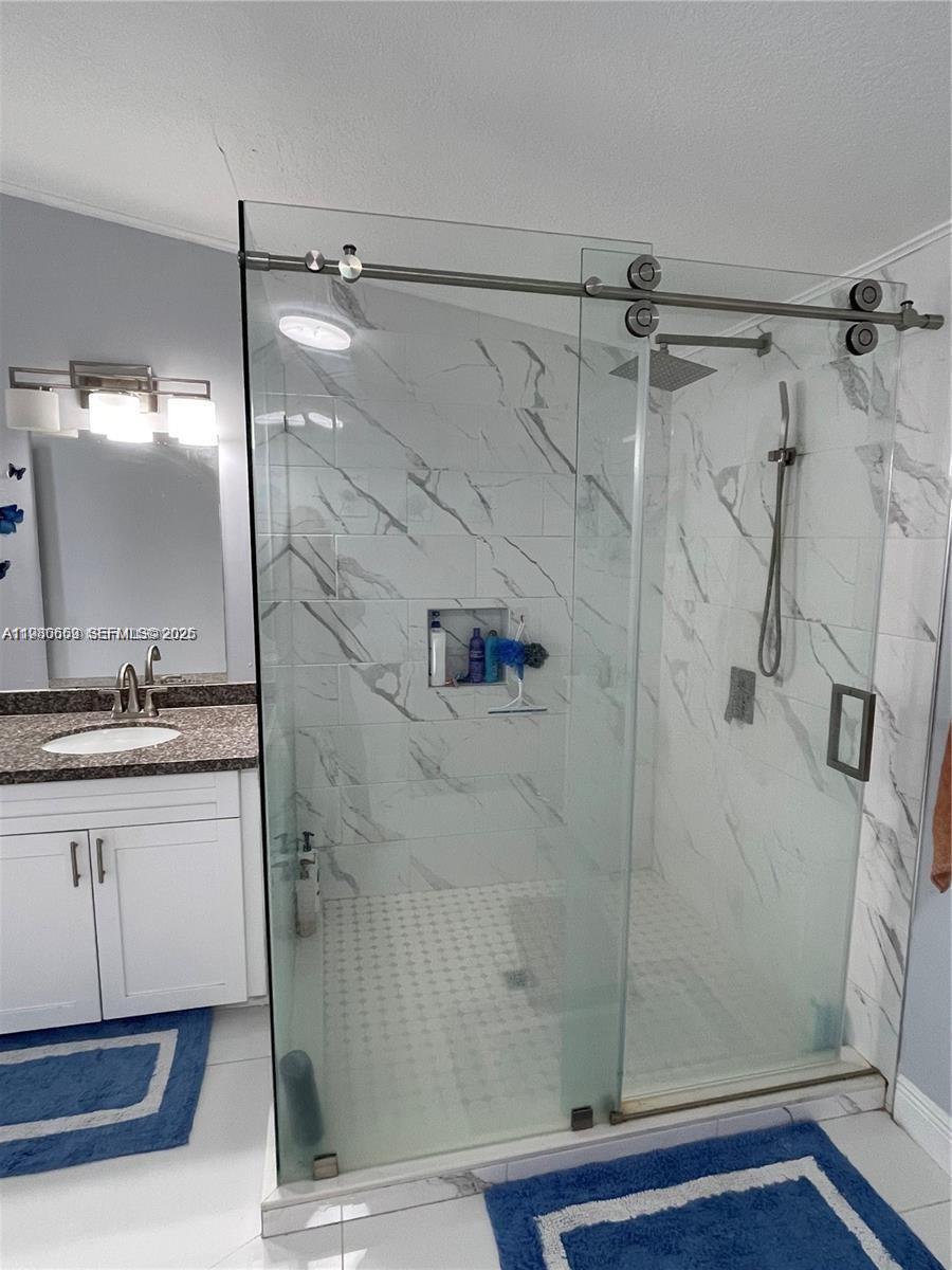 19800 Southwest 180th Avenue Miami, FL 33187 - Photo 6 of 9 a bathroom with a shower and a sink