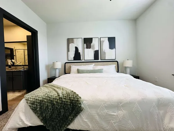 a bedroom with a bed and lamp