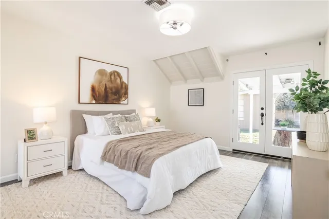 a bedroom with a large bed and a couch