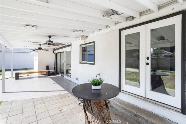 a view of a patio with table and chairs