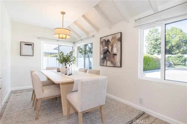 a view of a dining room with furniture wooden floor and chandelier