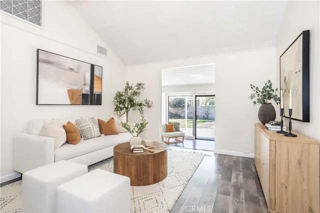 a living room with furniture a flat screen tv and a large window