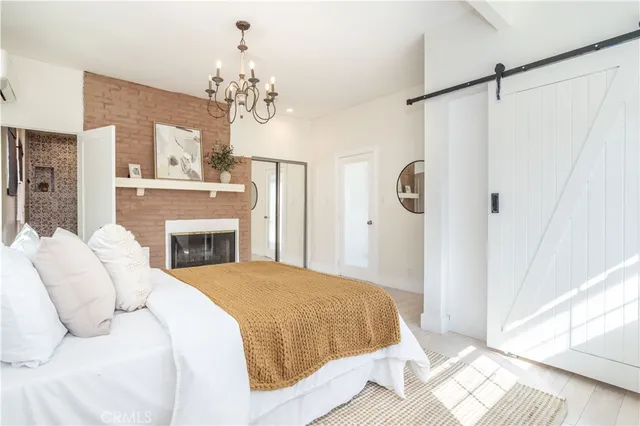 a spacious bedroom with a bed and a fireplace