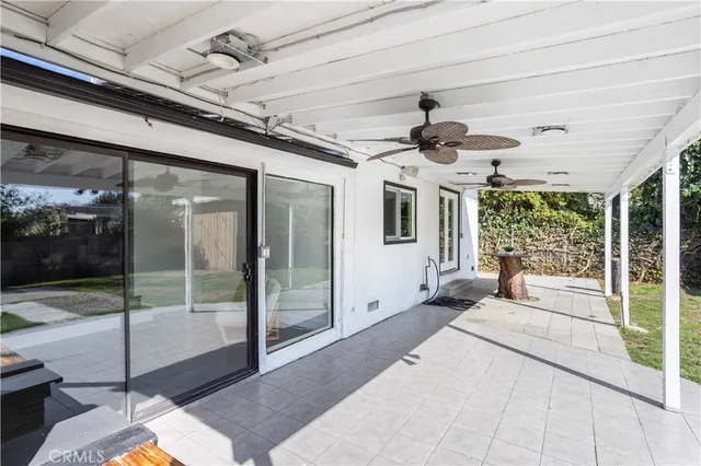 a view of a porch with a table and chairs