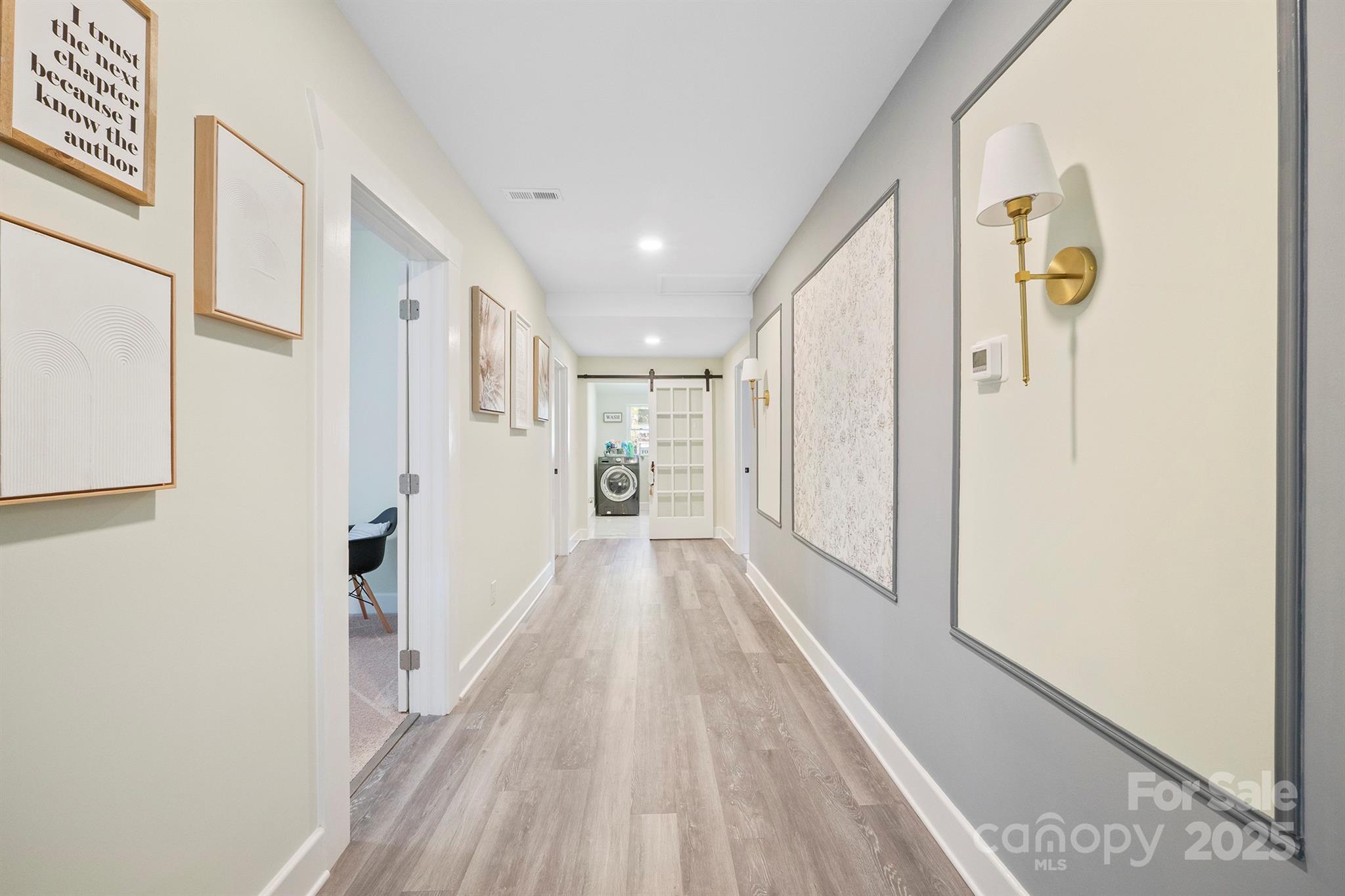 600 3rd Street Spencer, NC 28159 - Photo 11 of 27 a view of a hallway with wooden floor and staircase