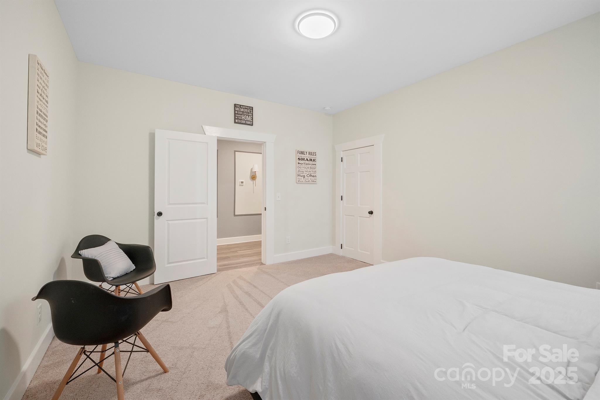 600 3rd Street Spencer, NC 28159 - Photo 17 of 27 a bedroom with a bed and a chair