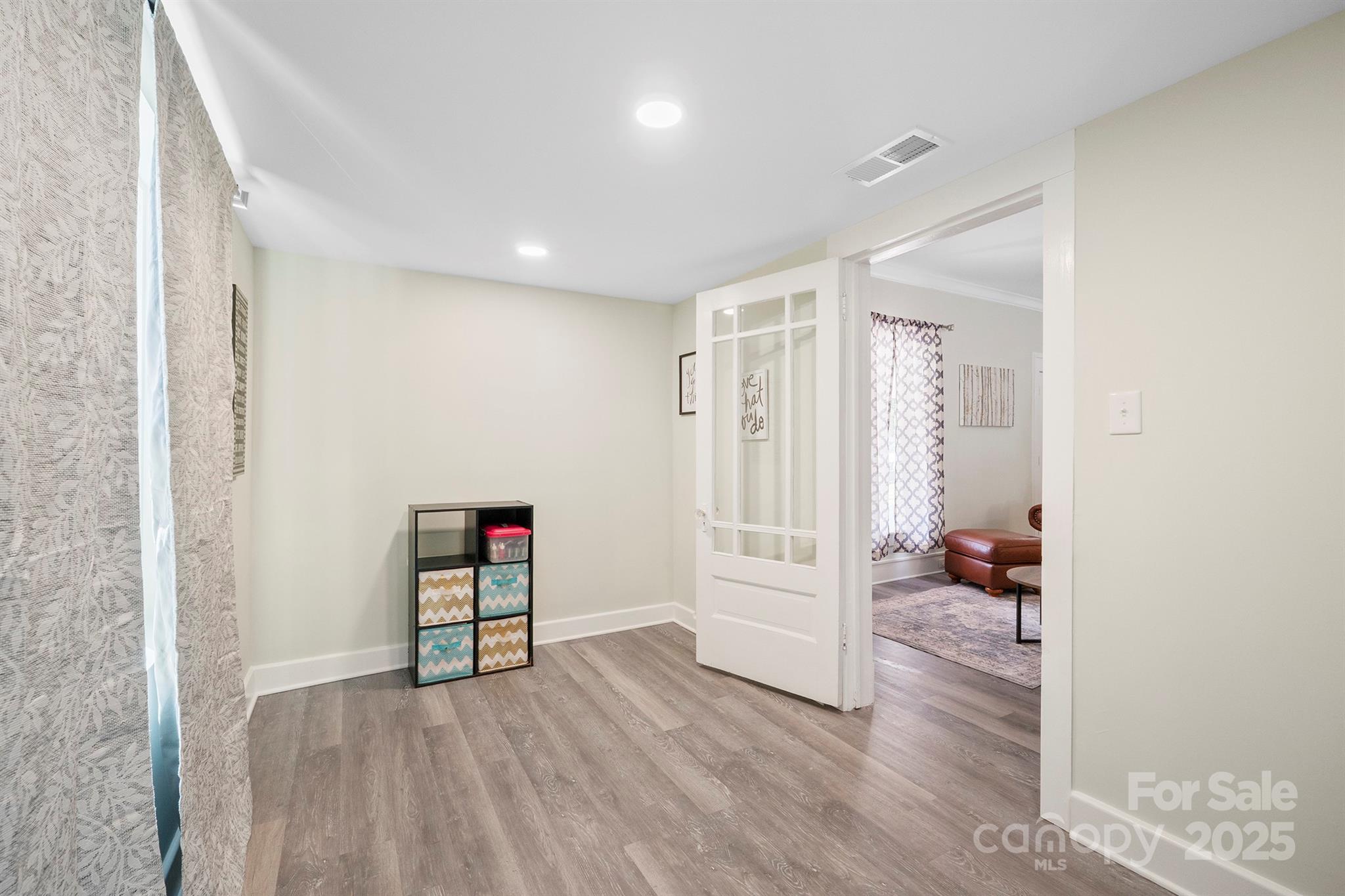 600 3rd Street Spencer, NC 28159 - Photo 22 of 27 an empty room with wooden floor and a bathroom