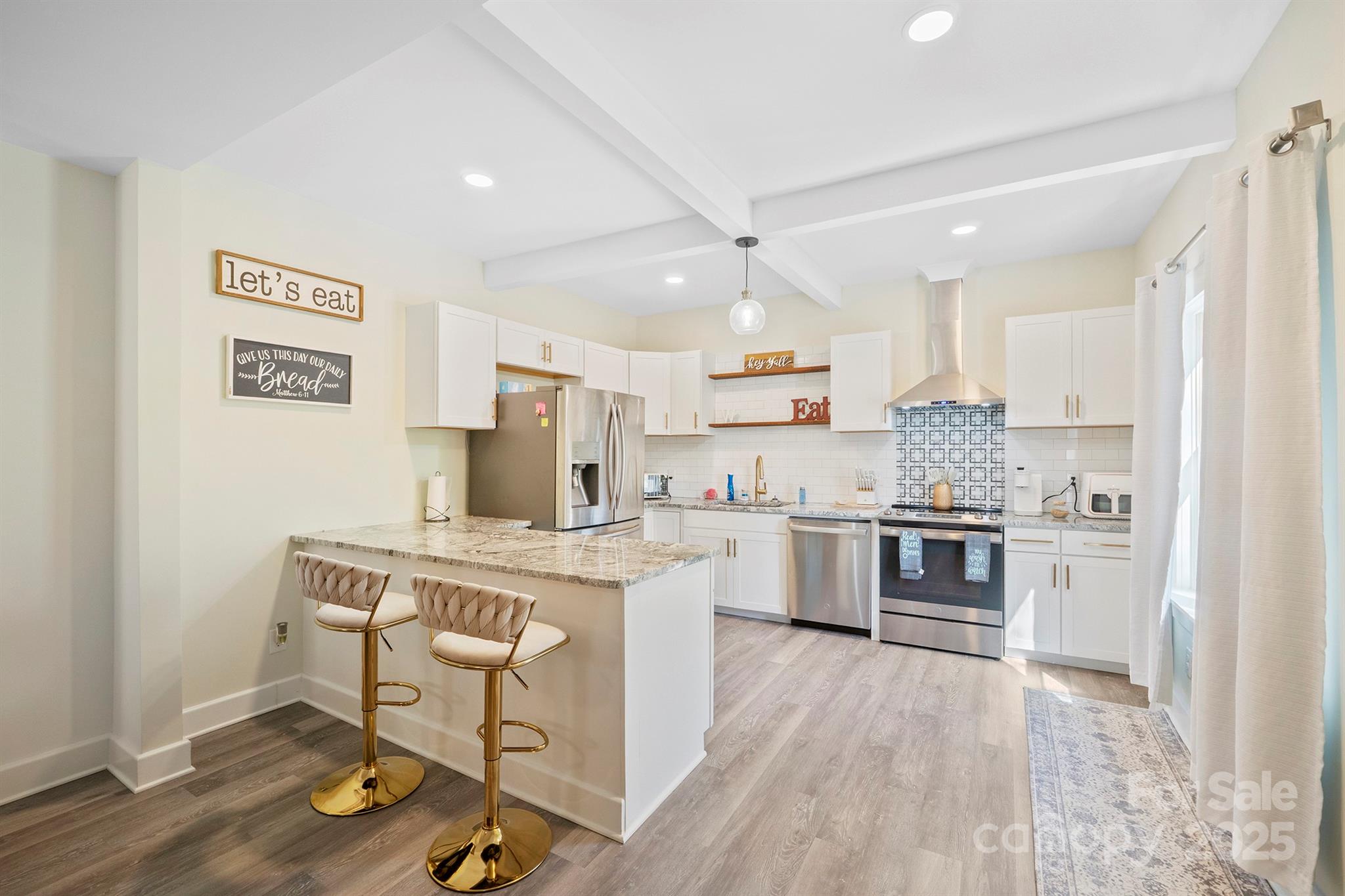600 3rd Street Spencer, NC 28159 - Photo 4 of 27 a kitchen with a stove a sink and a refrigerator
